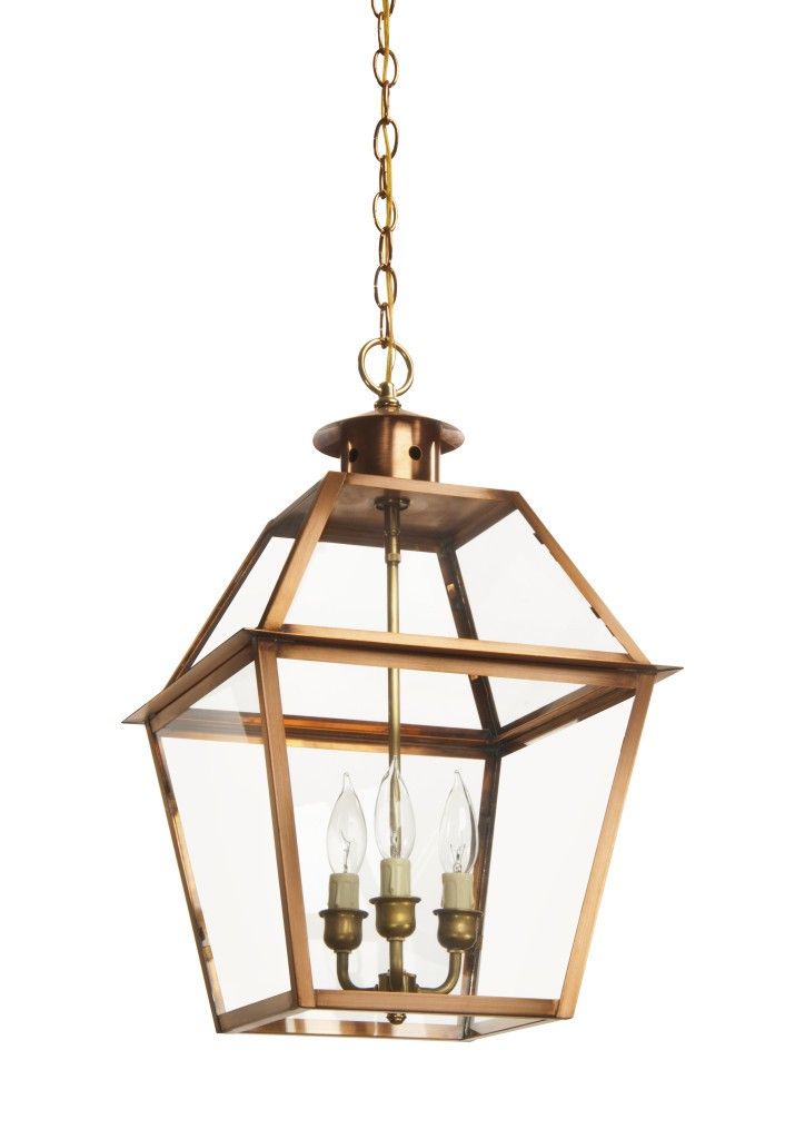 a hanging light fixture with two candles inside