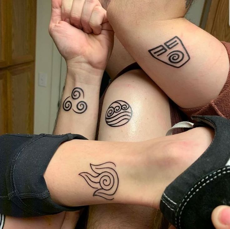 two people with matching tattoos on their arms