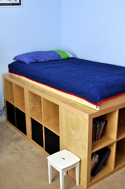 the bed is made up with bookshelves for storage