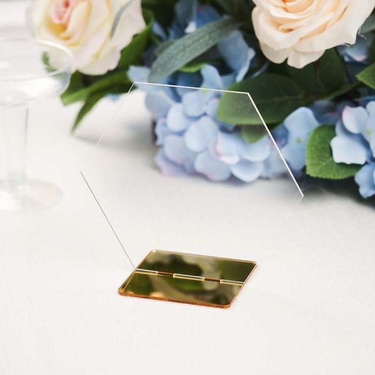 a table with flowers and some glasses on it