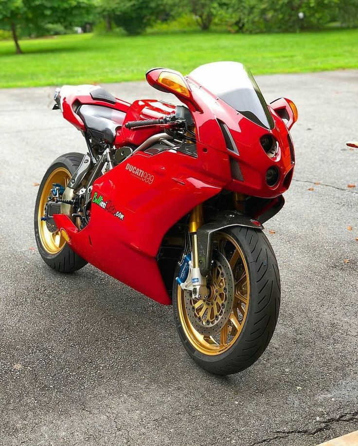 a red motorcycle is parked on the street