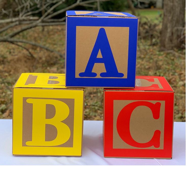 three blocks with the letters abc and c painted on them are sitting on a table