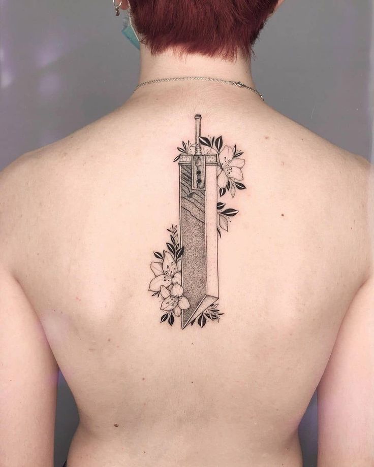 the back of a woman's neck with a tattoo on it