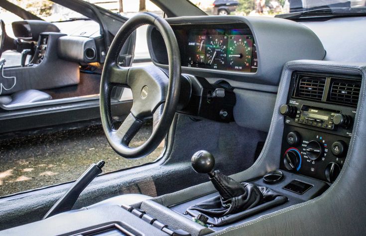 the interior of a car with steering wheel and dashboard