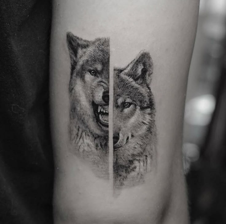 two wolf tattoos on the left thigh and one with an open mouth, both in black and white