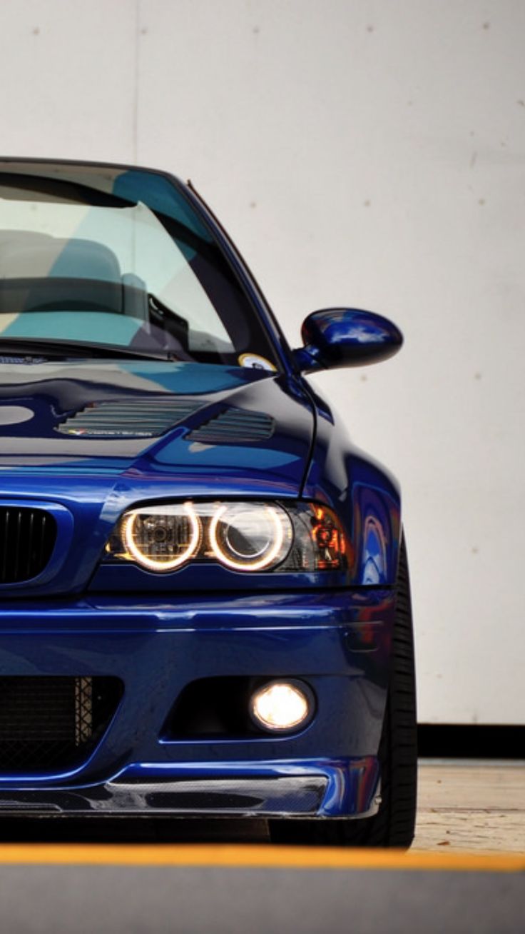 the front end of a blue bmw car