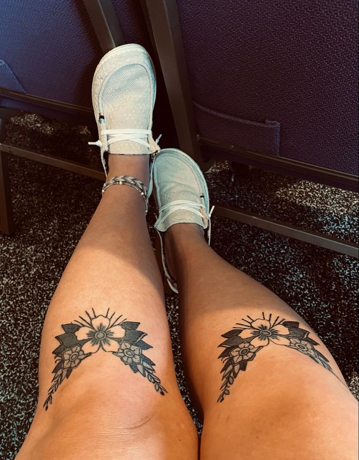 the legs of a woman with tattoos on them