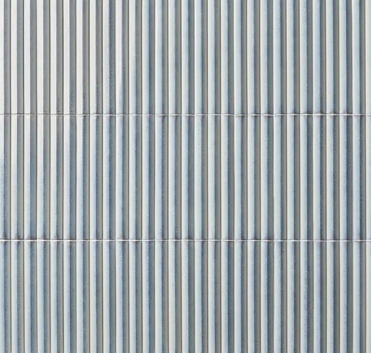 the side of a building with vertical lines painted on it