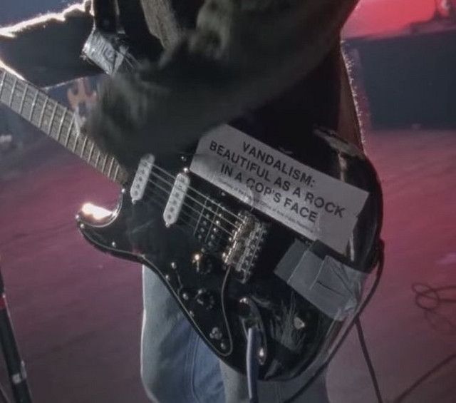 a man playing an electric guitar on stage