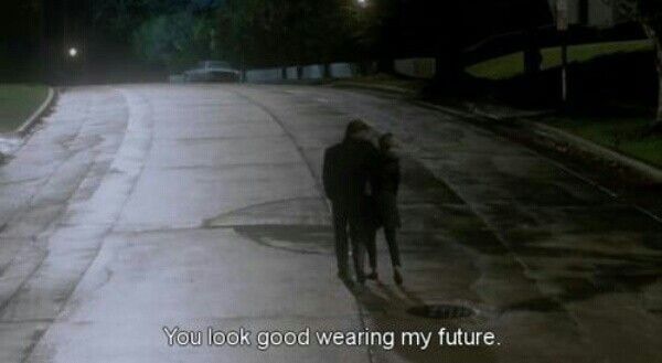 two people walking down the street at night