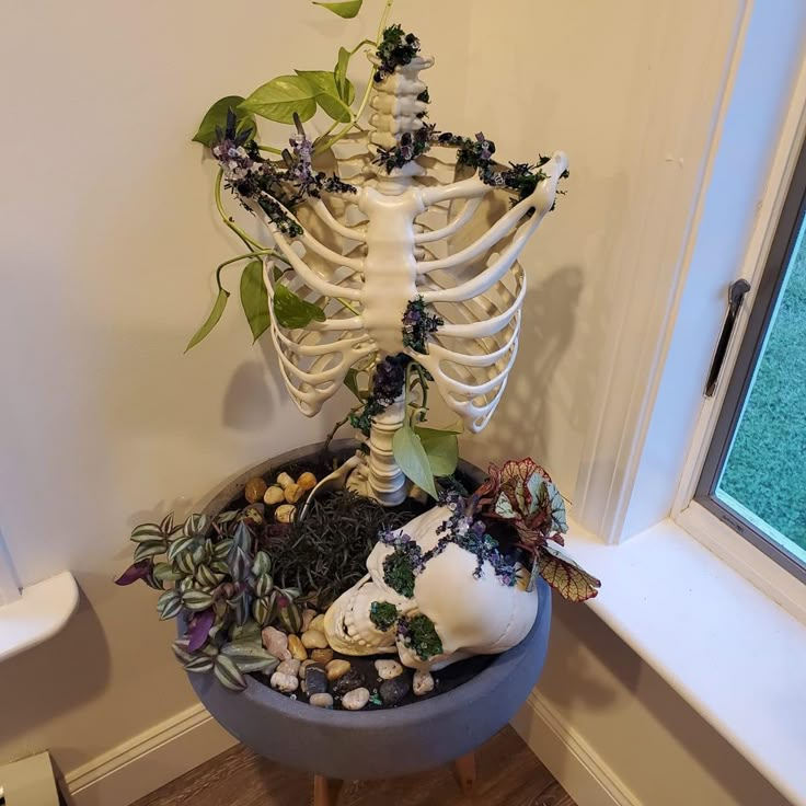 a skeleton planter with plants in it