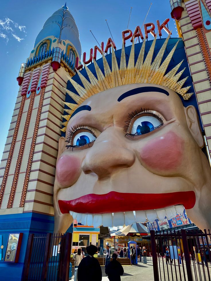 an amusement park with a giant statue of a man's head on the front