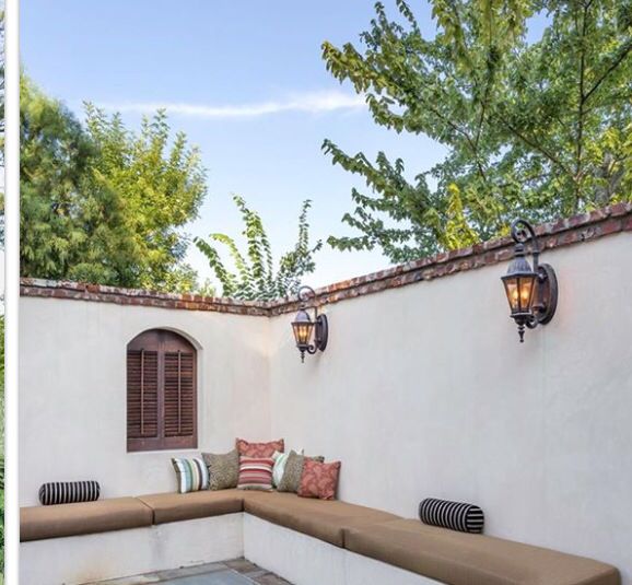 an outdoor seating area is shown in two different pictures, one with a bench and the other with pillows on it