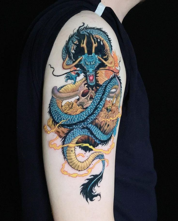 a person with a dragon tattoo on their arm