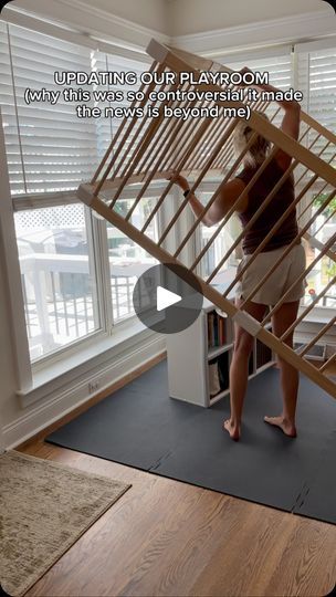 a woman standing on top of a wooden stair case