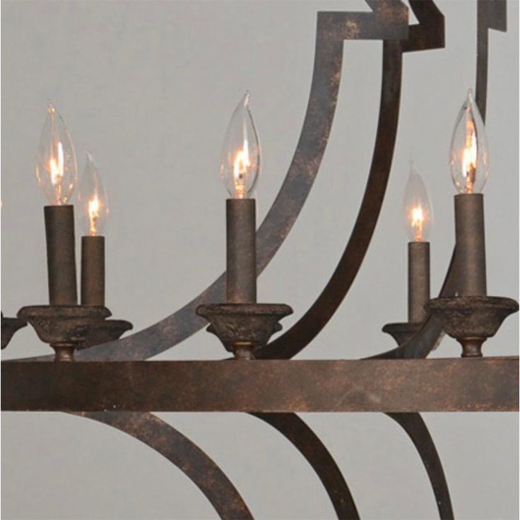 a chandelier with five lit candles hanging from it's arms and an iron frame