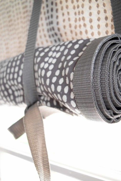 a close up of a piece of cloth on a window sill with a ribbon