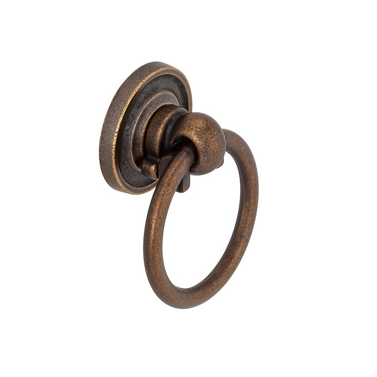 an antique brass towel ring on a white background