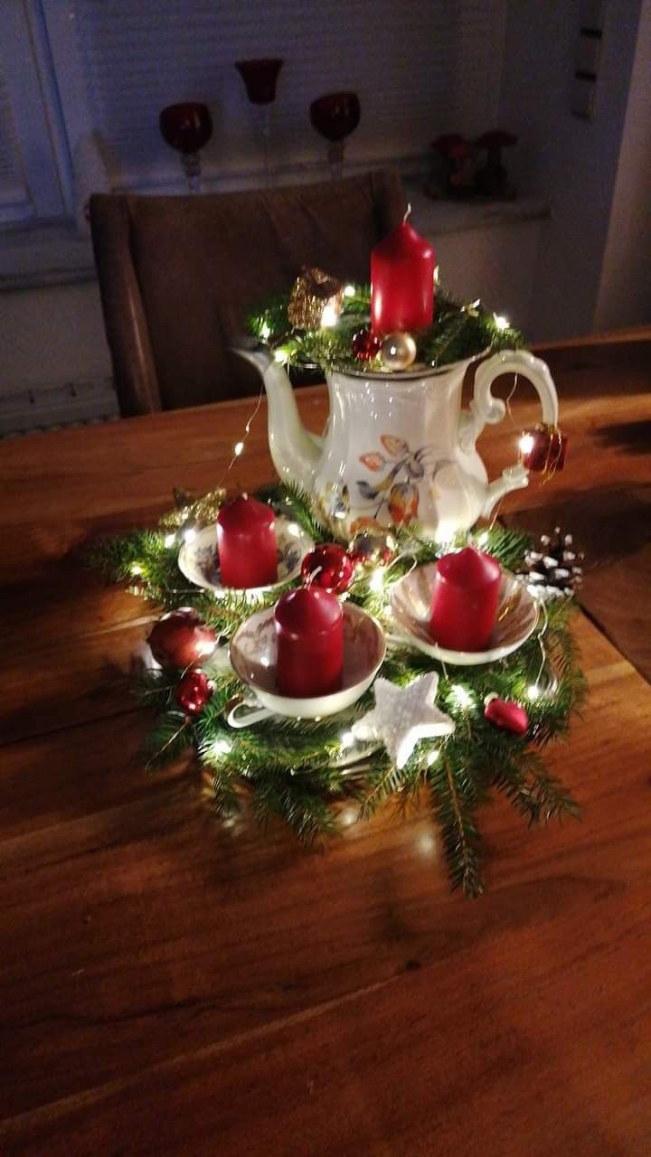 tea set with christmas decorations and lit candles