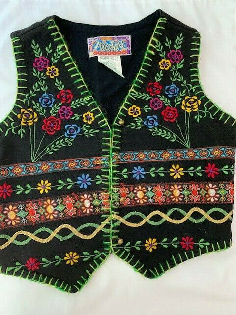 VINTAGE.  Black 100% cotton vest / waistcoat, 4 button, with bright colored stitching and flowers. Colors are Red, Blue, Purple, Green, and Yellow. Child's Small. Back has loop for tightening.   One button is missing top- needs to be replaced. Vintage Sleeveless Outerwear For Festivals, Vintage Fitted Vest For Fall, Fitted Vintage Outerwear For Festival, Retro Cotton Vest For Spring, Fitted Vest With Buttons For Festival, Fitted Retro Vest For Fall, Vintage Tops For Fall Festival, Bohemian Cotton Vest For Fall, Retro Fitted Vest For Fall