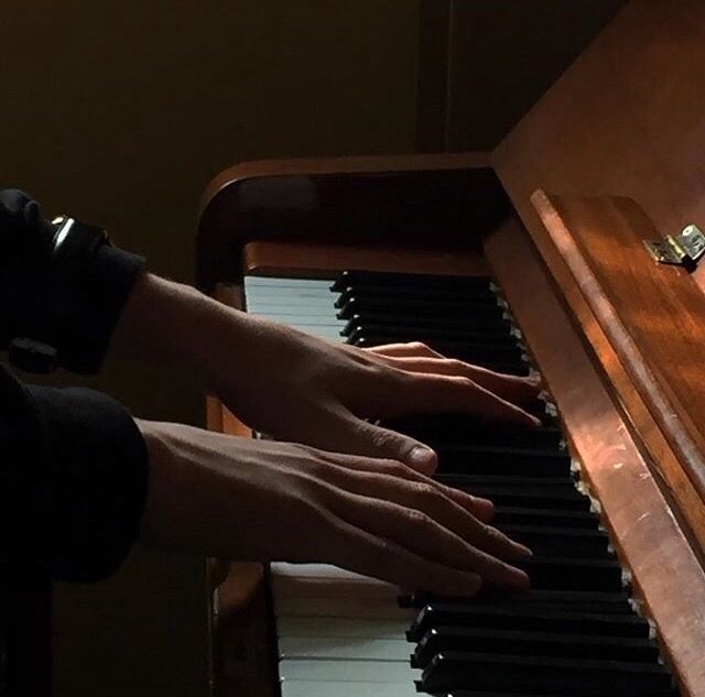 a person is playing the piano with their hands