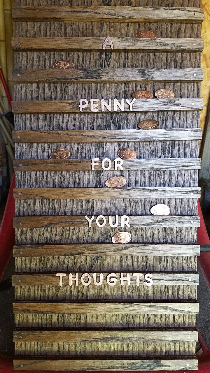 a stack of wooden signs that say penny for your thoughts