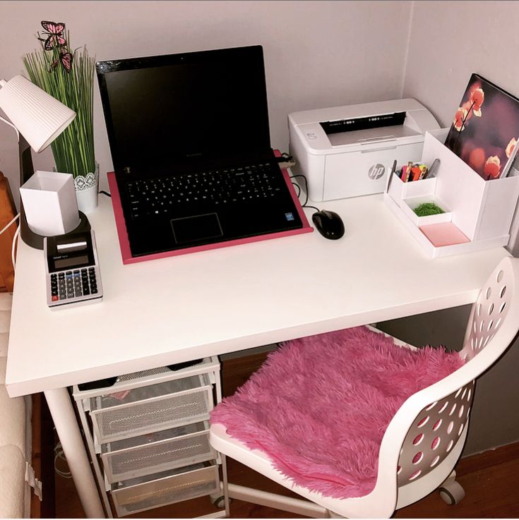 a laptop computer sitting on top of a white desk next to a printer and mouse