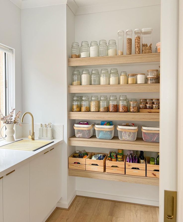 a kitchen filled with lots of shelves and containers on top of it's sides