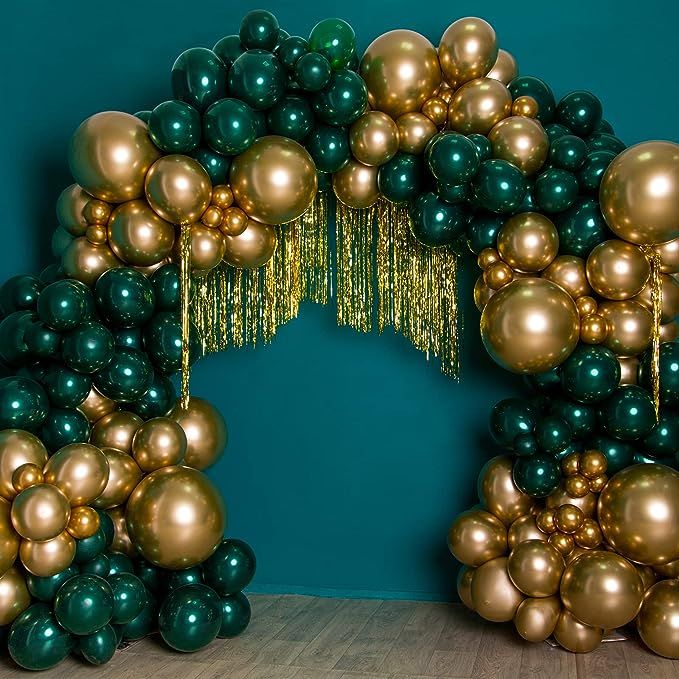 an arch made out of gold and green balloons