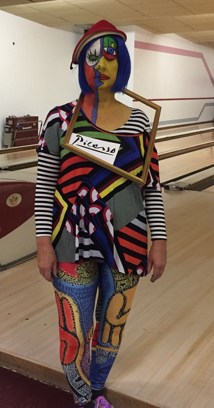 a woman in colorful clothing standing on top of a bowling alley