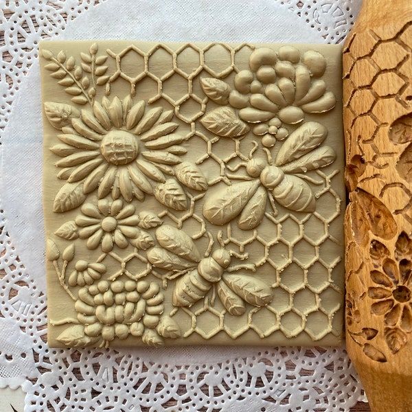 two wooden spoons sitting next to each other on a doily