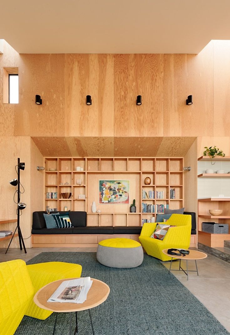 a living room filled with furniture and wooden walls