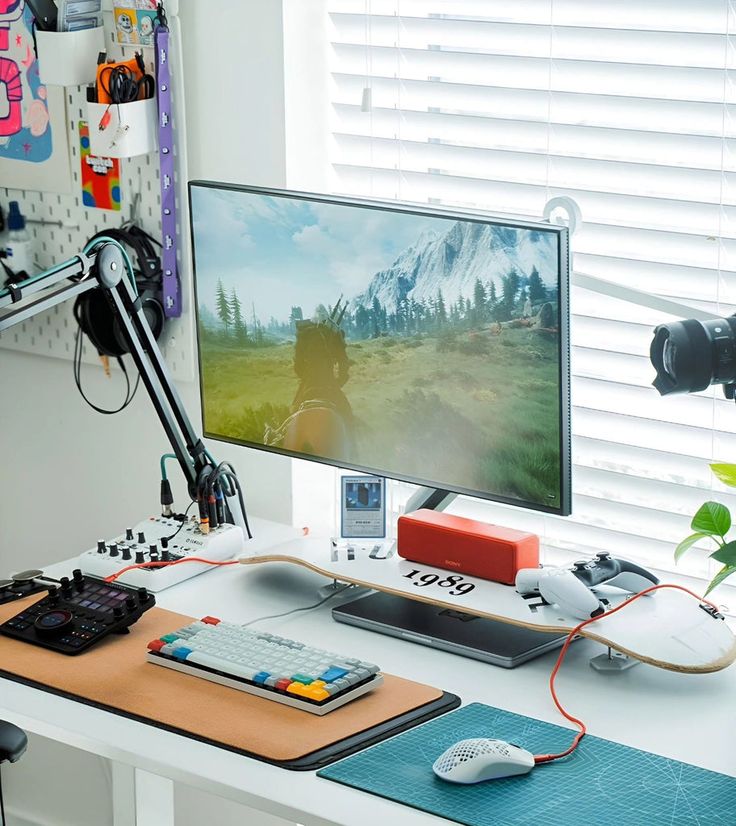 a computer monitor sitting on top of a desk next to a keyboard and mouse pad