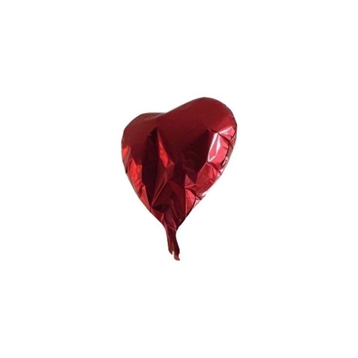 a red heart shaped balloon floating in the air