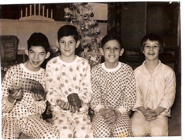 an old black and white photo of four children in pajamas