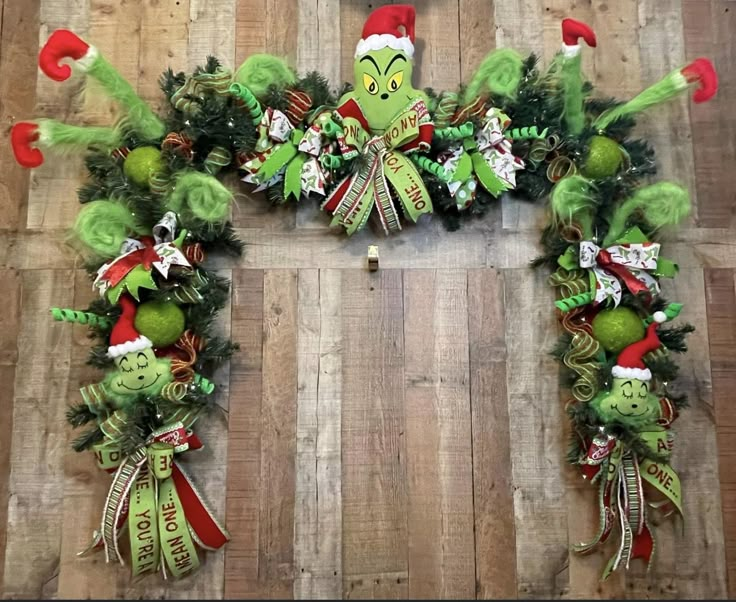 the grinch wreath has been decorated with green and red decorations