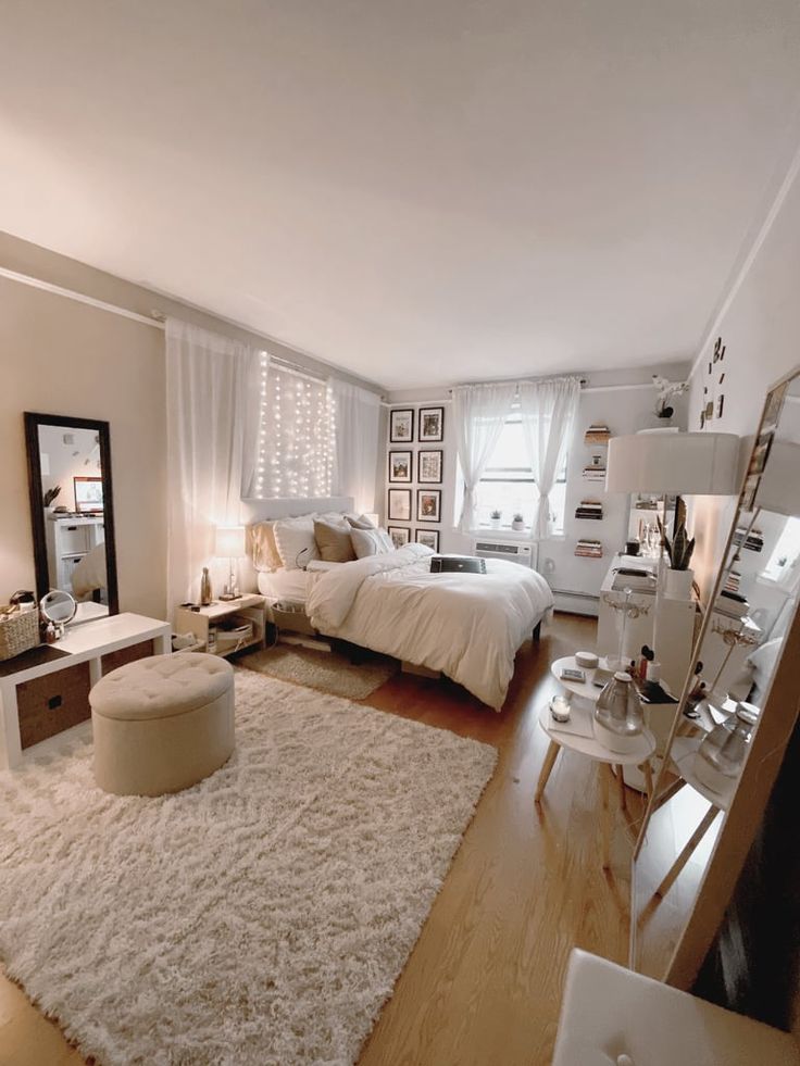 a bedroom with a white rug and wooden floors