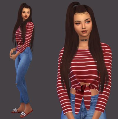 a woman with long hair wearing jeans and a striped shirt