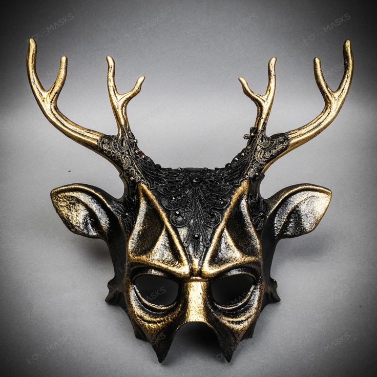 Mystery And Allure With Our Antler Deer Textured Horn With Brushed Gold Laces Devil Halloween Masquerade Mask In Black. Perfect For Anyone Seeking An Unforgettable Halloween Costume Or Masquerade Accessory, This Mask Combines The Wild Elegance Of Antler Deer Horns With The Mysterious Charm Of A Masquerade. Crafted From Durable Plastic, The Mask Features A Textured Design That Mimics The Aged Look Of Antique Artifacts, Painted In A Popcorn Textured Black To Enhance Its Appeal. Measuring Approxima Steampunk Halloween Party Masks, Horned Masquerade Mask For Halloween, Black Punk Masks For Party, Black Punk Party Masks, Punk Black Party Masks, Horned Masquerade Mask For Halloween Costume Party, Horned Masks And Prosthetics For Halloween Party, Fantasy Horned Masks And Prosthetics For Party, Halloween Party Horned Masks And Prosthetics