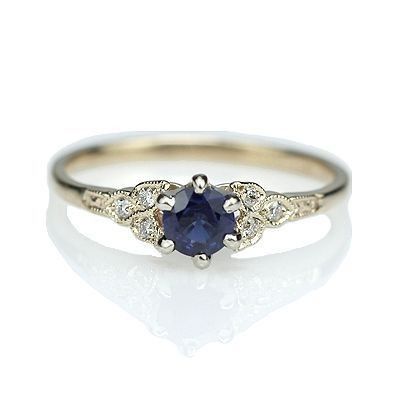 an engagement ring with a blue sapphire and diamond accents