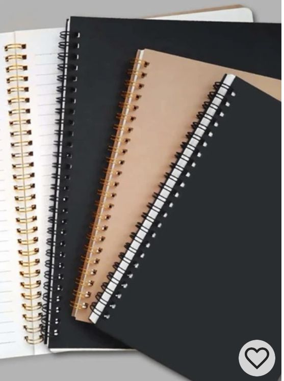 three spiral notebooks lined up next to each other