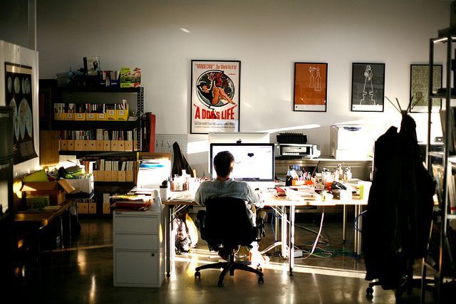 a person sitting at a desk in front of a computer