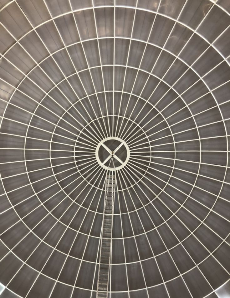 the inside of a large metal structure with a clock on it's center piece