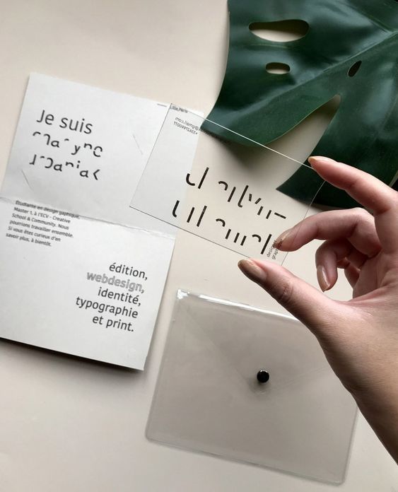 a person is pointing at some type of paper on a table with other papers and magnets