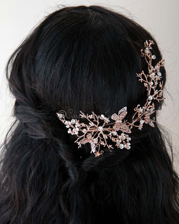 a close up of a woman wearing a hair comb with flowers and leaves on it