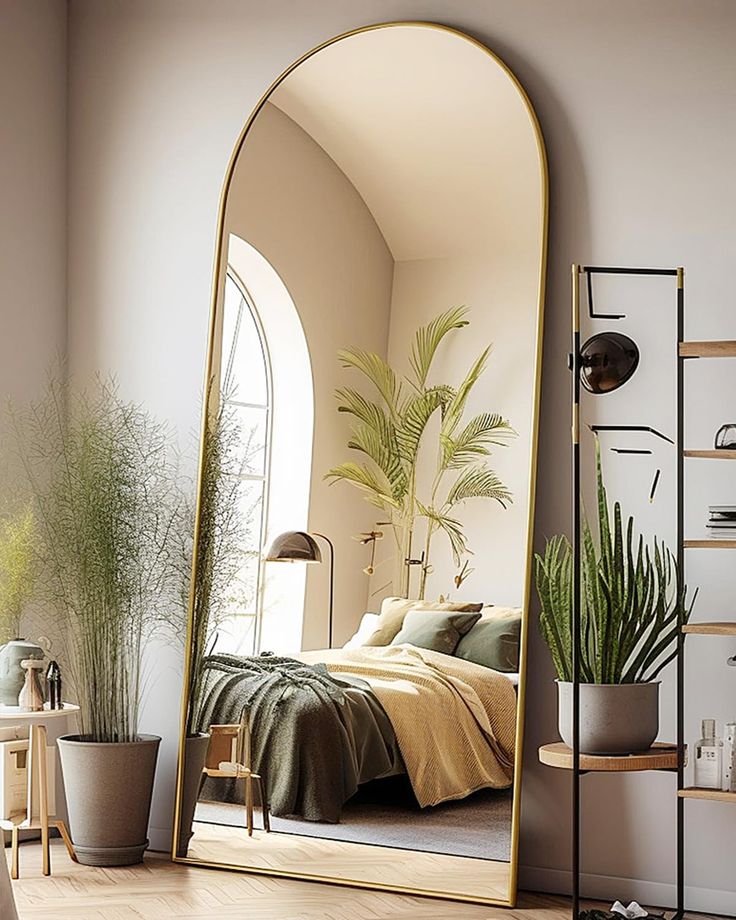 a bedroom with a large mirror on the wall next to a bed and potted plants