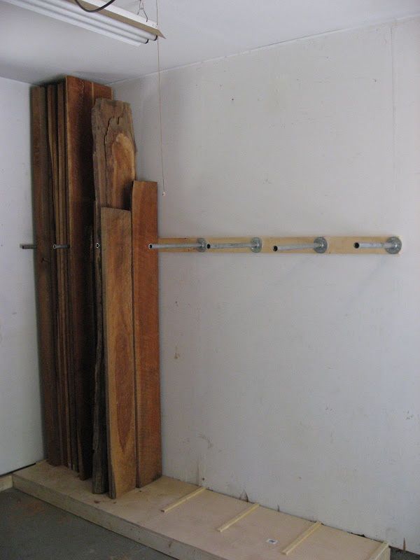 an unfinished room with some wooden pieces on the floor and a door in the wall