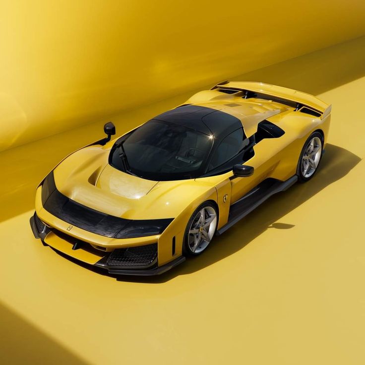 a yellow sports car is shown from the top down, on a yellow background with shadows