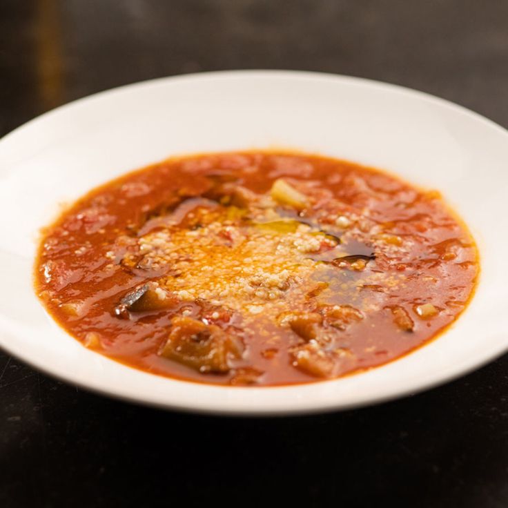 a white bowl filled with soup on top of a table