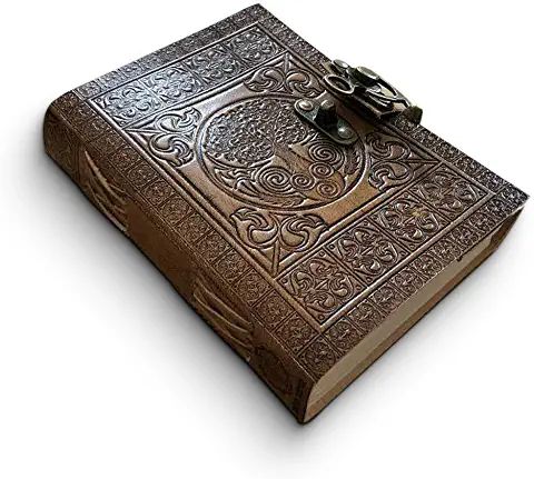 an old leather book with intricate designs on the front and back cover is open to reveal a key